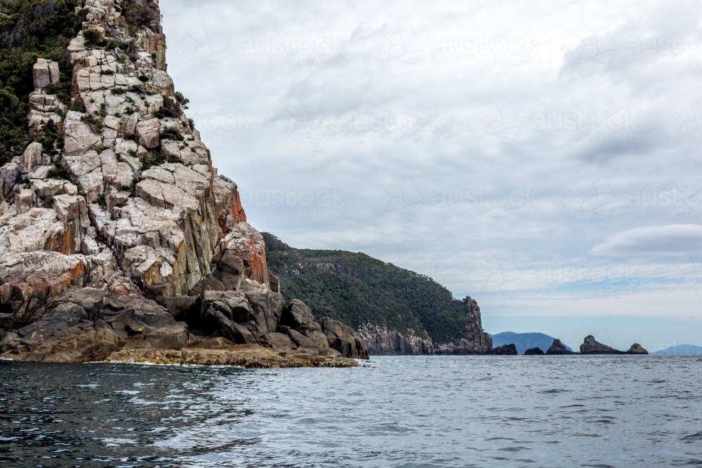 A view of towering sea cliffs from the water - Australian Stock Image