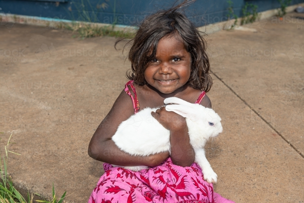 Aboriginal child with pet rabbit - Australian Stock Image