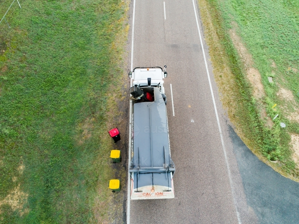 Aerial photo of garbage truck emptying bins in rural location - Australian Stock Image