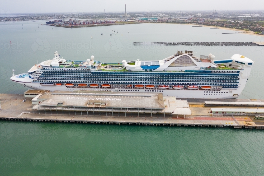 Aerial view of a large cruise ship docked at shipping terminal - Australian Stock Image