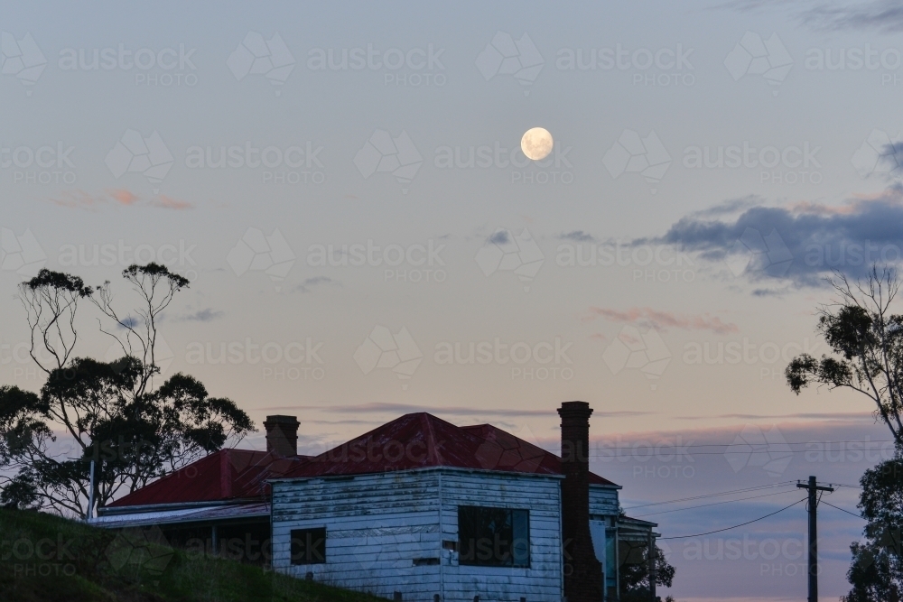 An old country homestead under a full moon - Australian Stock Image