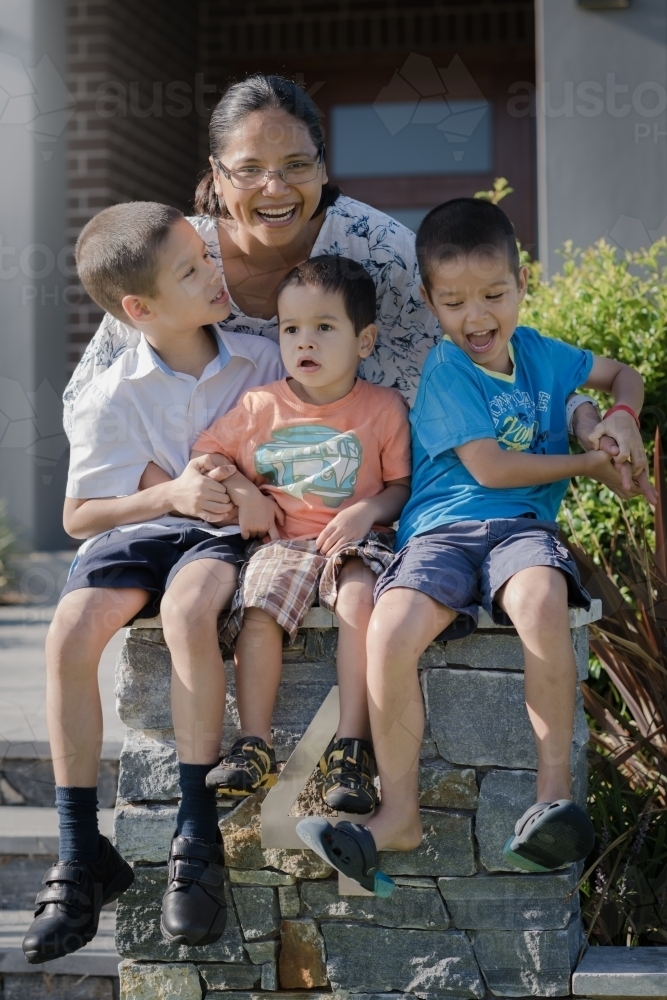 Asian mum sending her boys off to school on their first day of school - Australian Stock Image