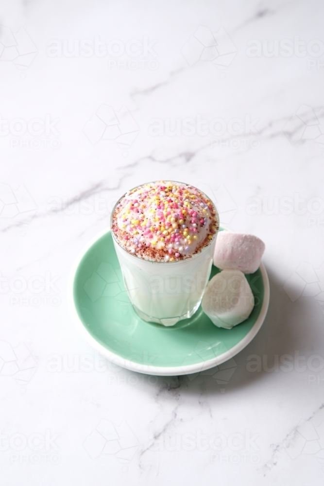 Babyccino on teal saucer with side of marshmallows - Australian Stock Image