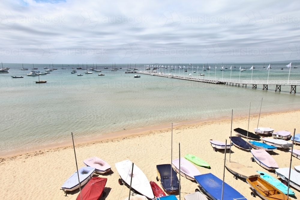 Boats on sunlit beach - Australian Stock Image