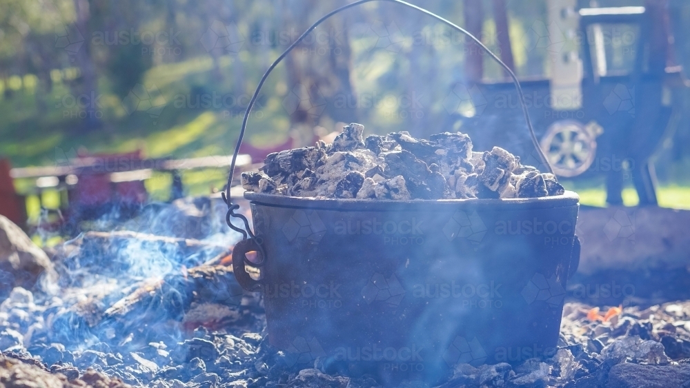 Camp oven with smokey background - Australian Stock Image