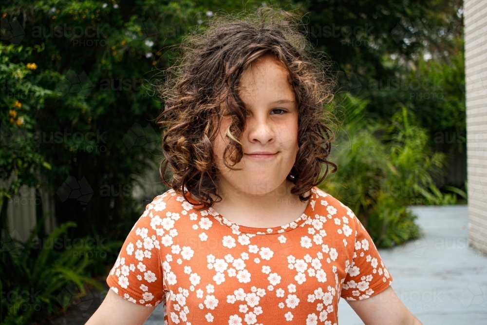 Close up shot of a girl with curly hair - Australian Stock Image