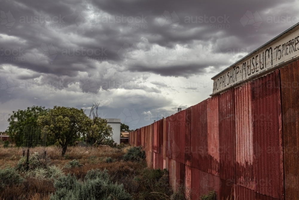 Clouds over rusty fence - Australian Stock Image