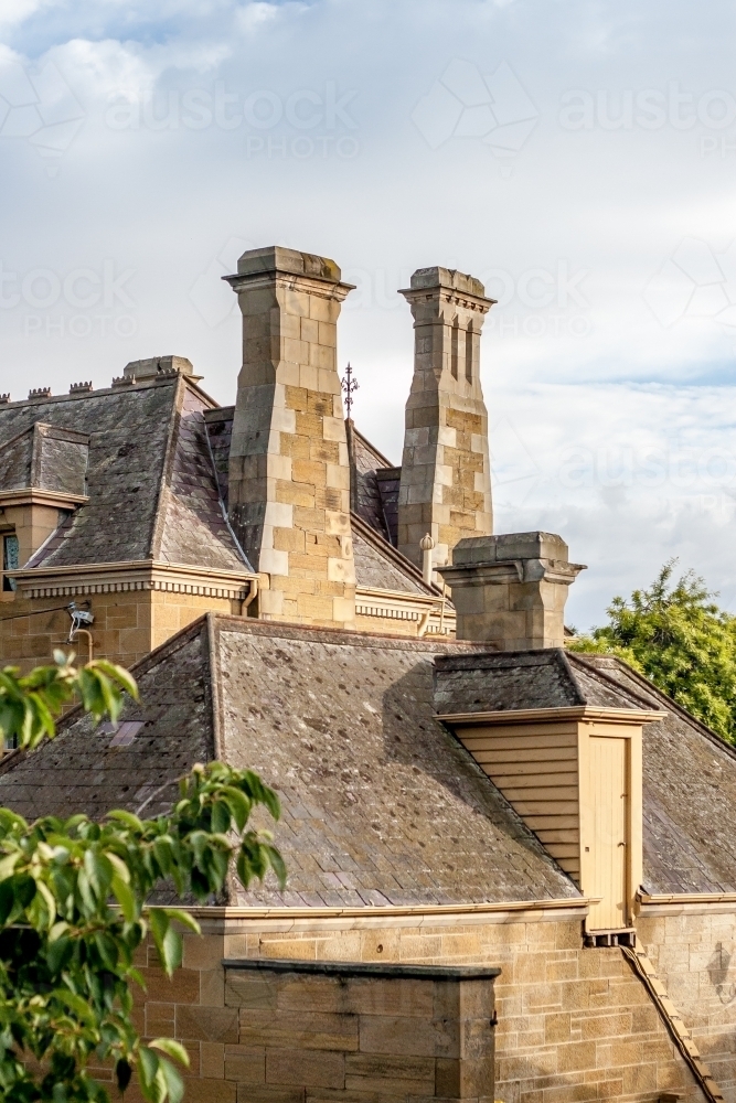 Convict sandstone chimney stacks in the early morning sunlight - Australian Stock Image