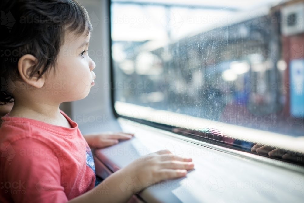 Cute 2 year old boy travels on a Sydney train - Australian Stock Image