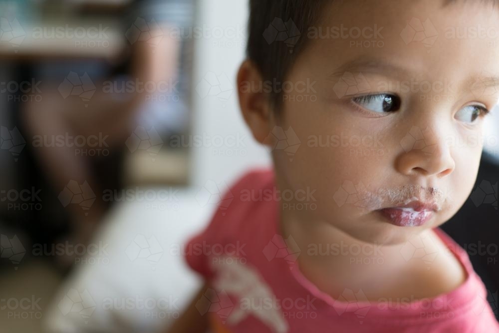 Cute mixed race kids drinking a babychinno in a neighbourhood cafe - Australian Stock Image