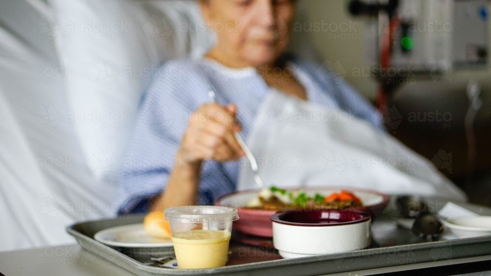 Female patient dining on hospital food - Australian Stock Image