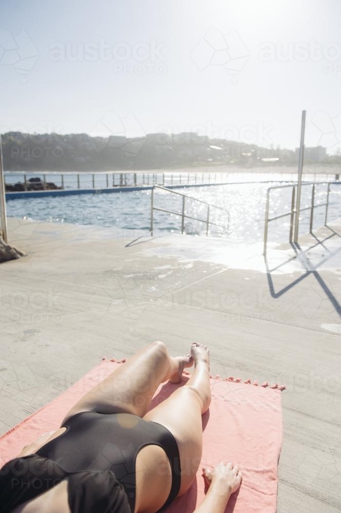 Female Sunbaker by the Ocean Pool - Australian Stock Image