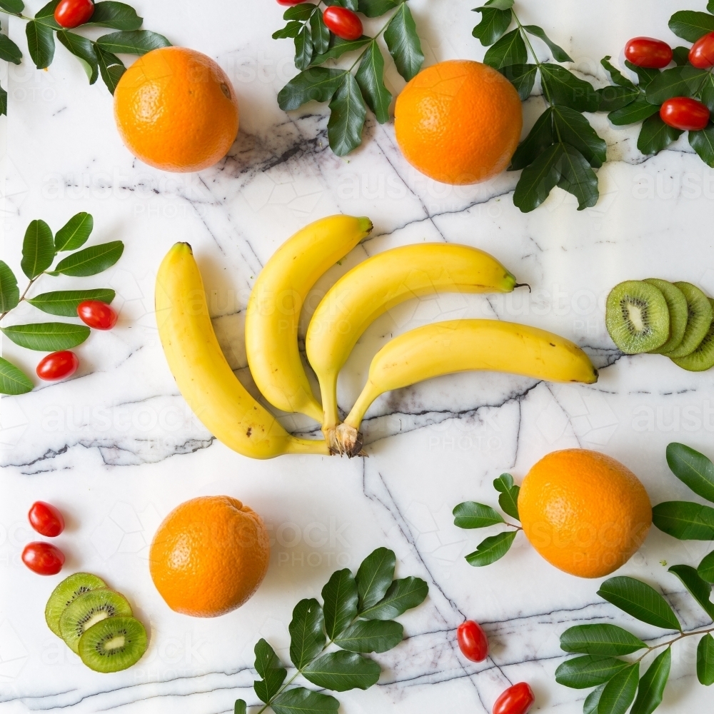 Festive flatlay of Fruit - Bananas, Oranges, Kiwi, Cherry Tomatoes - Australian Stock Image