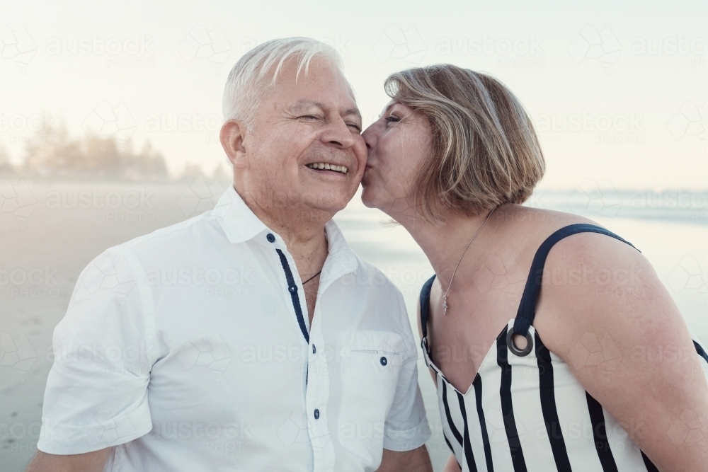 Happy multicultural senior couple on the beach - Australian Stock Image