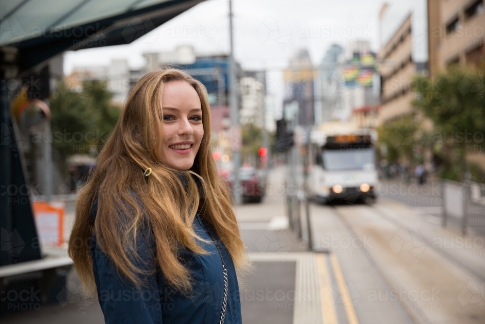 Happy Woman About to Catch the Tram - Australian Stock Image