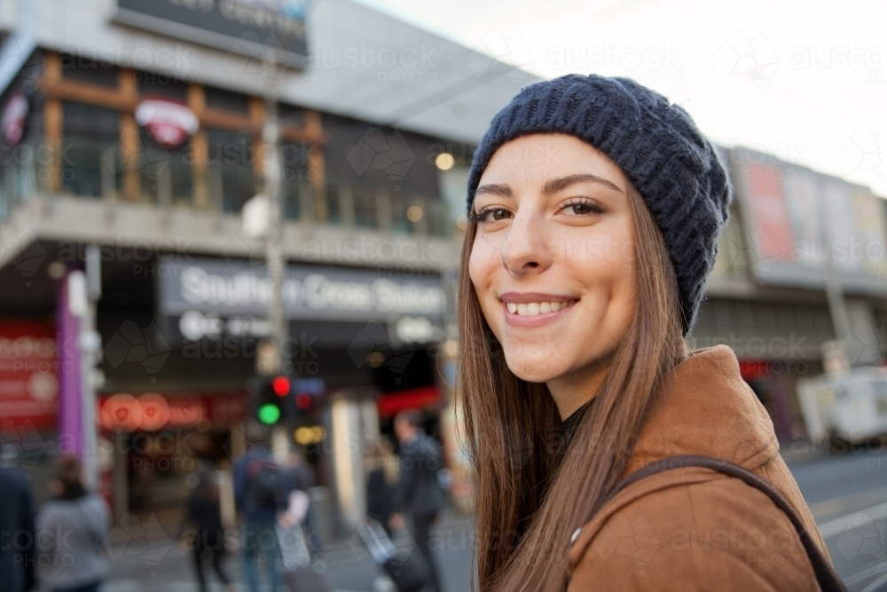 Happy woman walking through Melbourne city - Australian Stock Image