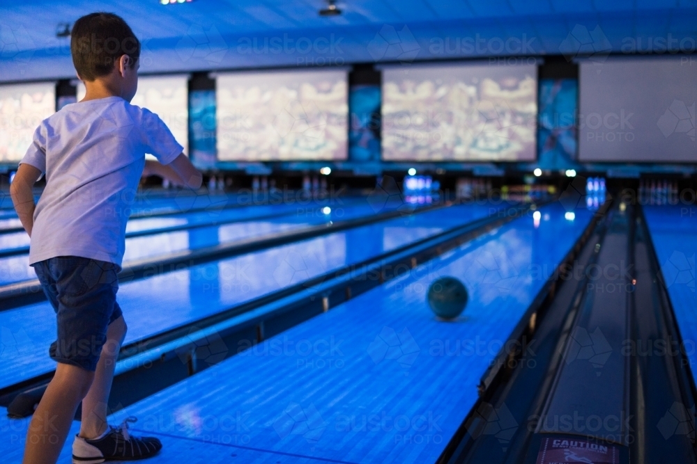 Kids 10 pin bowling under blue lights - Australian Stock Image