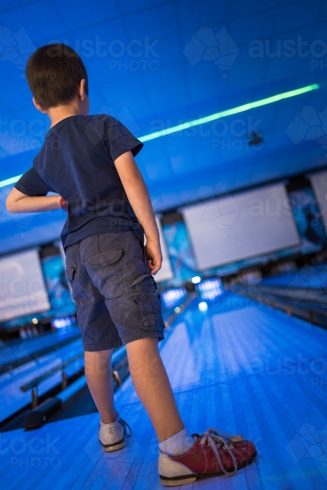 Kids 10 pin bowling under blue lights - Australian Stock Image
