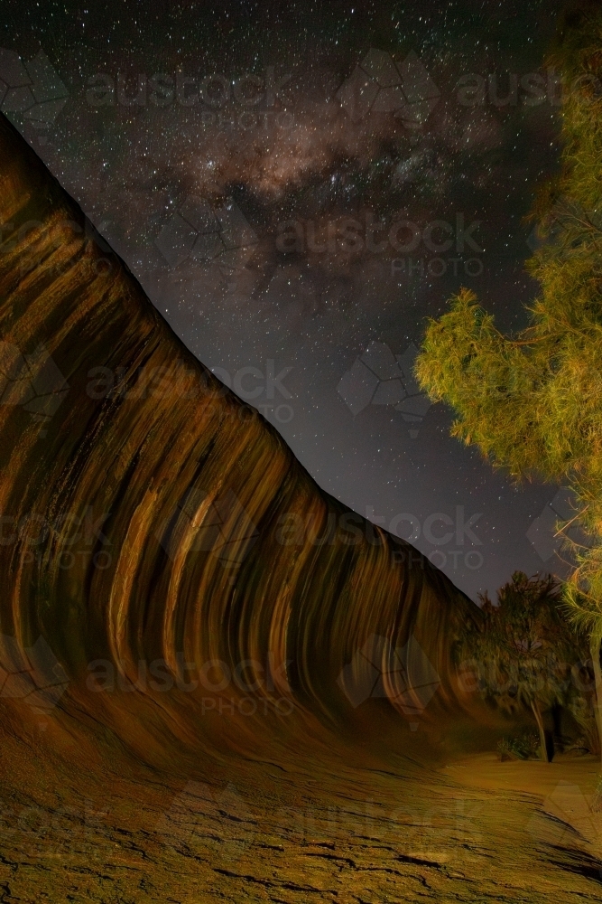 Light-painting on Wave Rock under the Milky Way. - Australian Stock Image