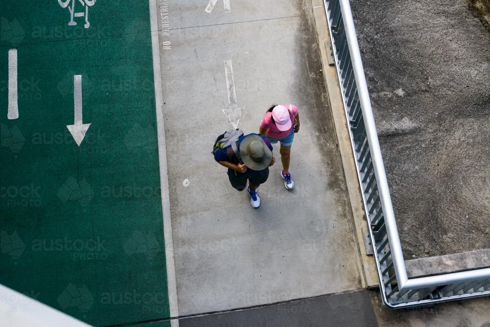 Man and woman walking on shared pathway - Australian Stock Image