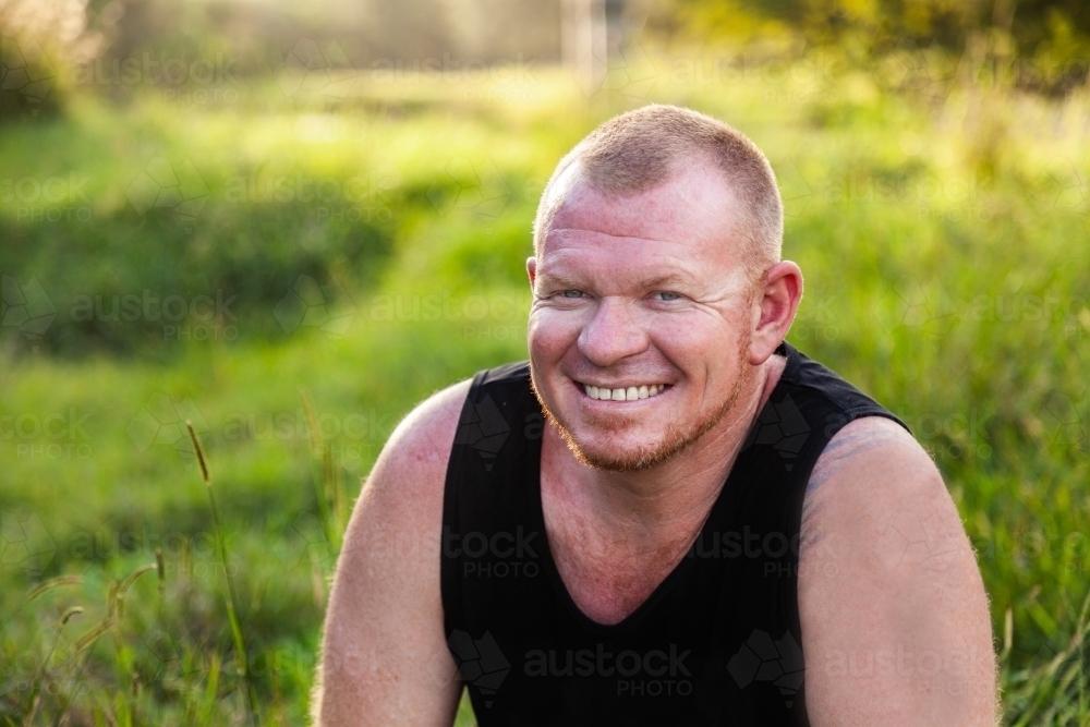 Man outside in nature with a happy grin on his face - Australian Stock Image