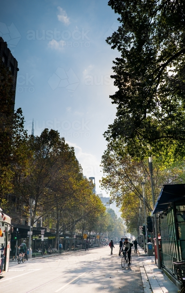 Melbourne city street scene with cyclist - Australian Stock Image