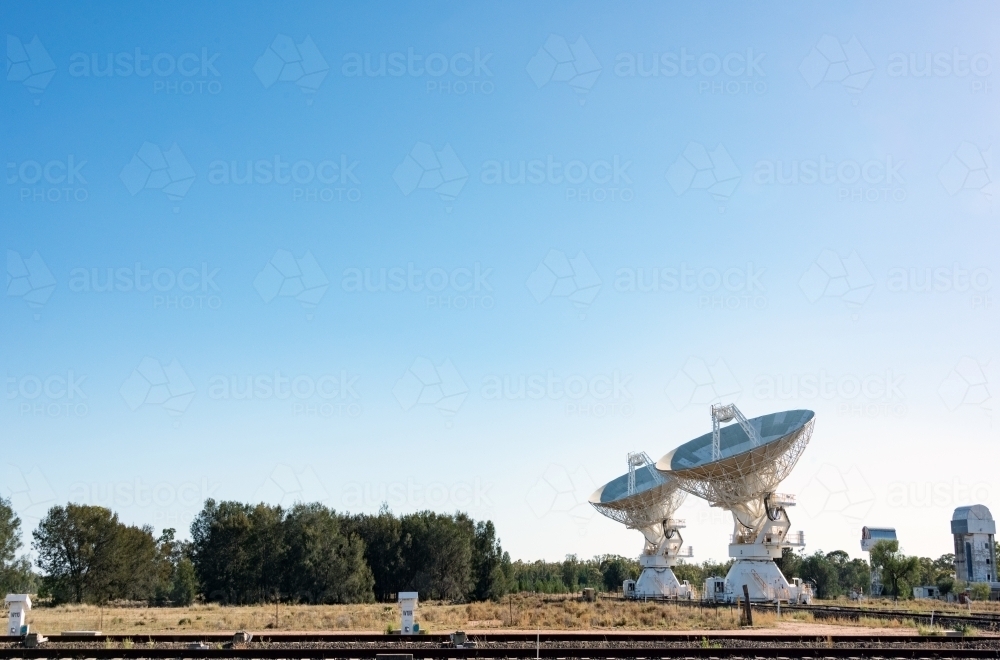 Multiple radio telescopes facing the blue sky day - Australian Stock Image