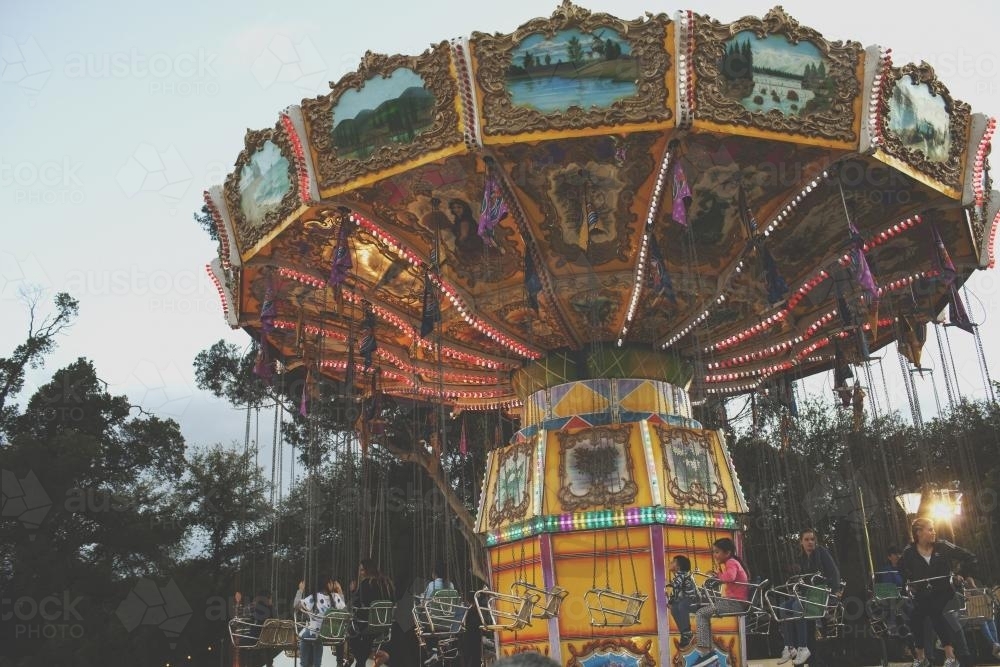 Old fashioned swinging carousel Carnival Ride - Australian Stock Image