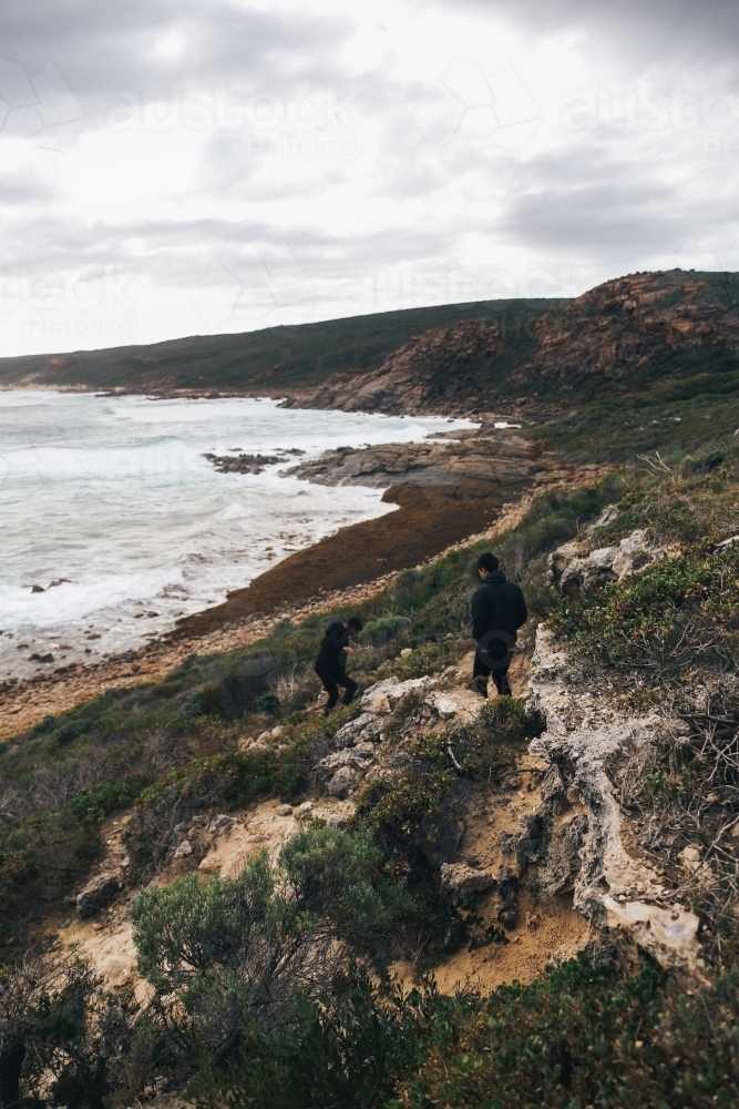 Overcast coastal landscape with two anonymous people - Australian Stock Image