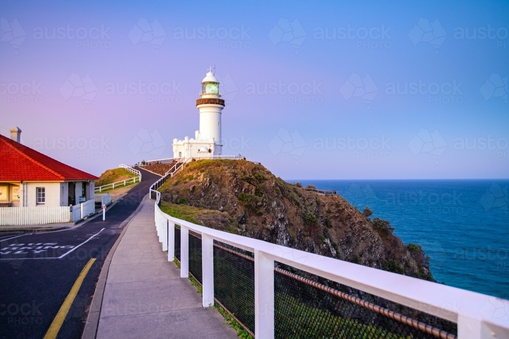 Path leading up to Byron Bay Lighthouse at dawn with pink colours - Australian Stock Image