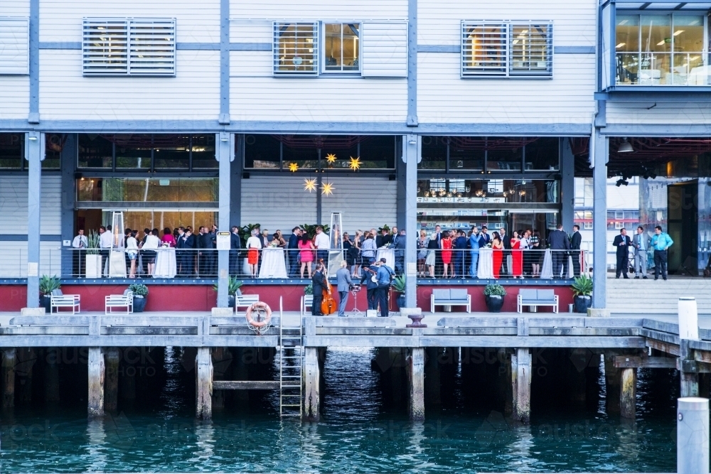 People celebrating at a party over the water - Australian Stock Image