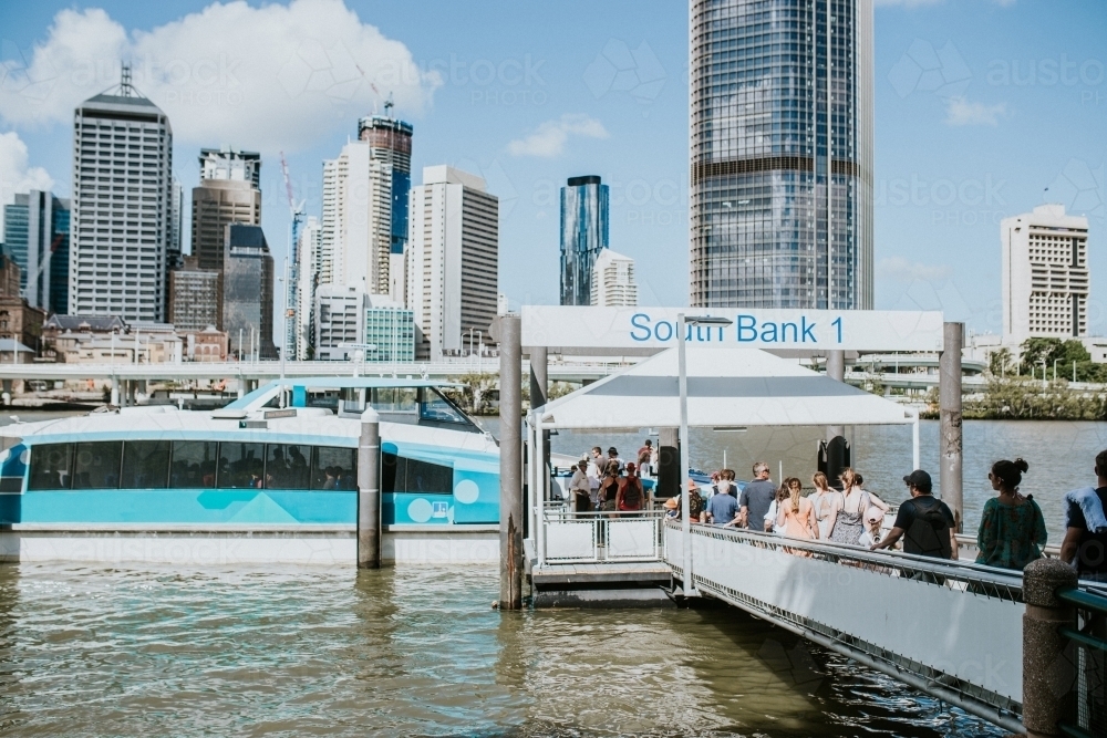 People lined up to board the City Cat boat at South Bank - Australian Stock Image