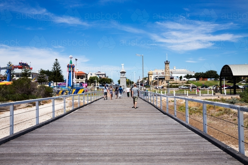 People walking on jetty with buildings in background - Australian Stock Image