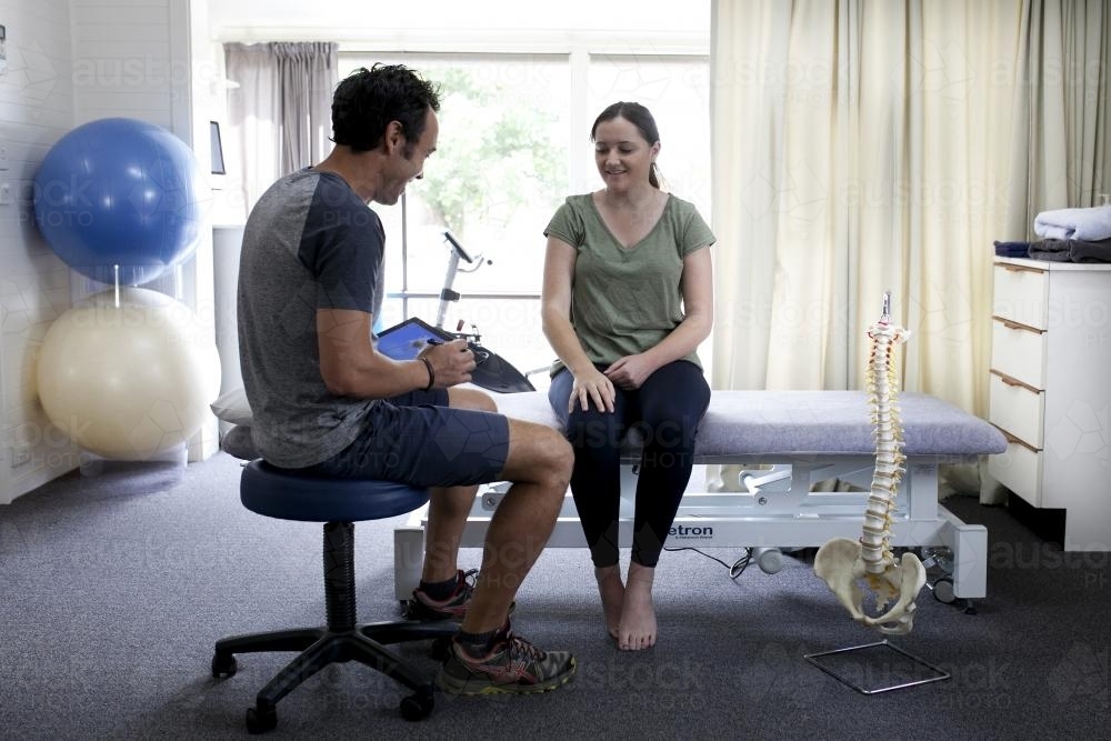 Physiotherapist assessing patient in clinic - Australian Stock Image
