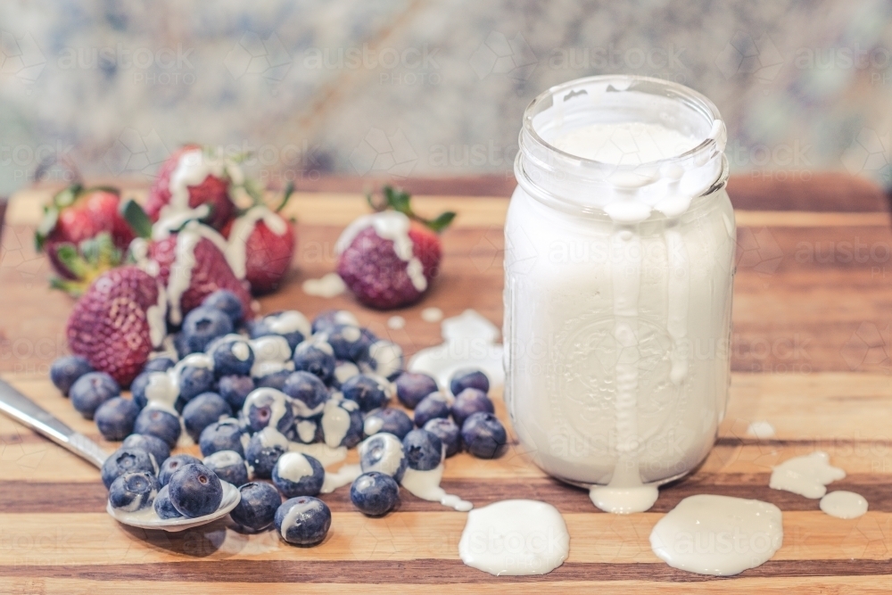 Plater of homemade coconut yoghurt with blueberries and strawberries - Australian Stock Image
