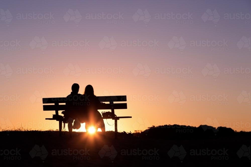 Silhouette of a couple at sunset - Australian Stock Image
