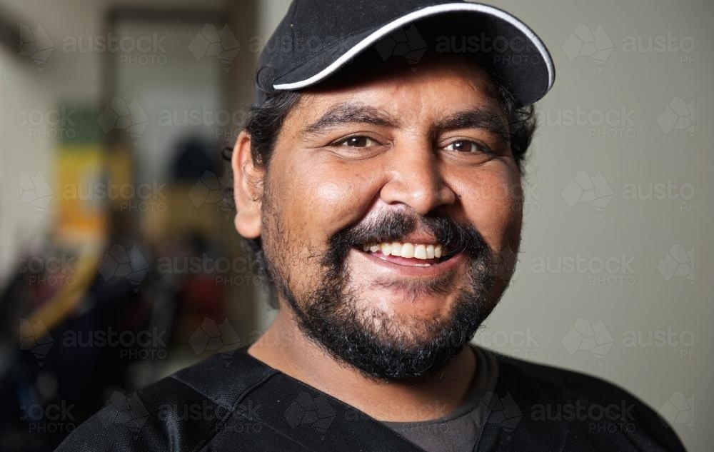 Twenty five Year Old Aboriginal Man Smiling Broadly - Australian Stock Image