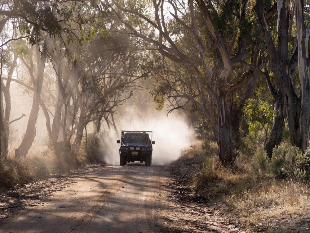 Vehicle travelling along a dusty dirt road - Australian Stock Image