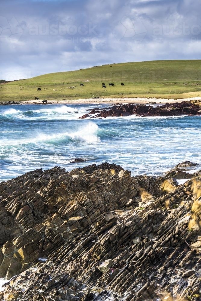 Waves crash into the dramatic King Island shoreline - Australian Stock Image