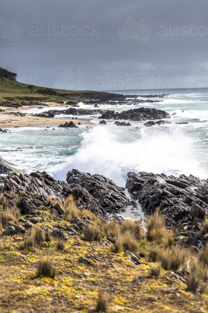 Waves crashing into the dramatic King Island shoreline - Australian Stock Image