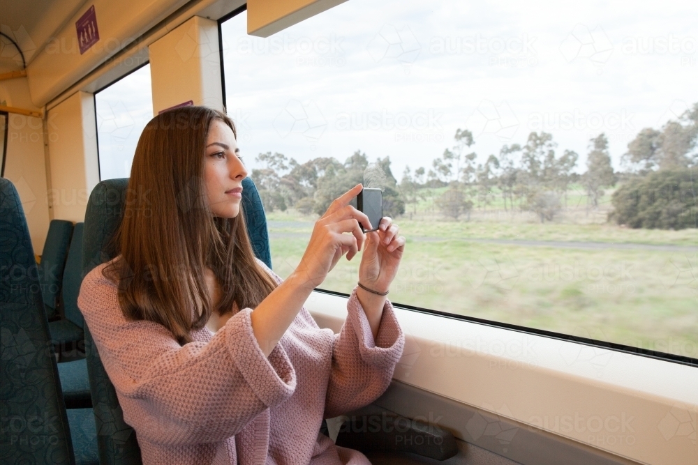 Woman Taking Photo on the Train - Australian Stock Image