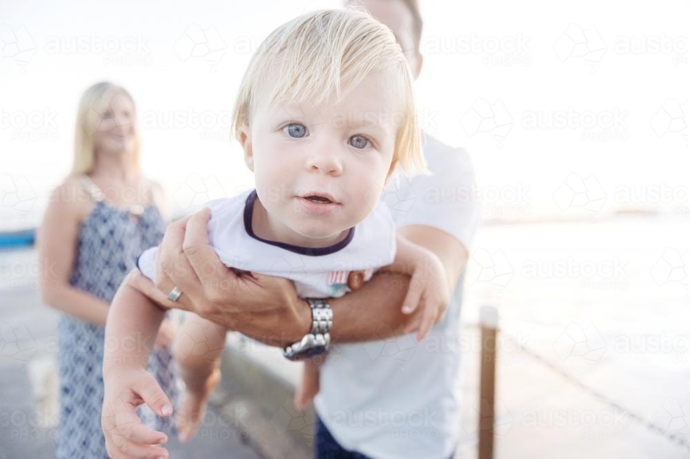 Young Boy in dads arms up close to the camera - Australian Stock Image
