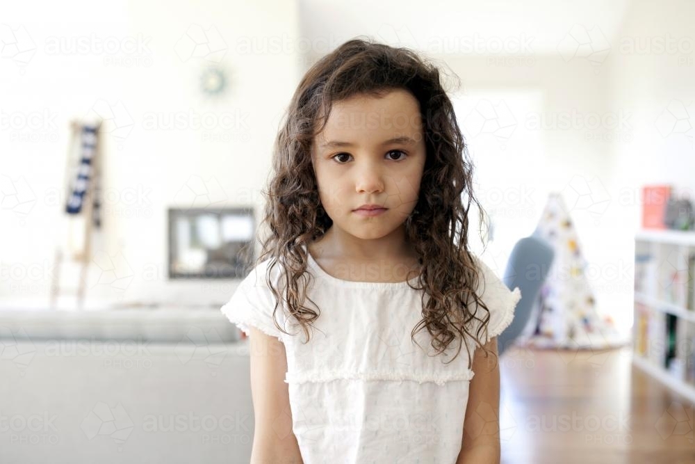 Young girl in living room of home - Australian Stock Image