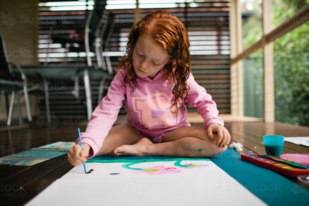 Young girl painting a picture - Australian Stock Image