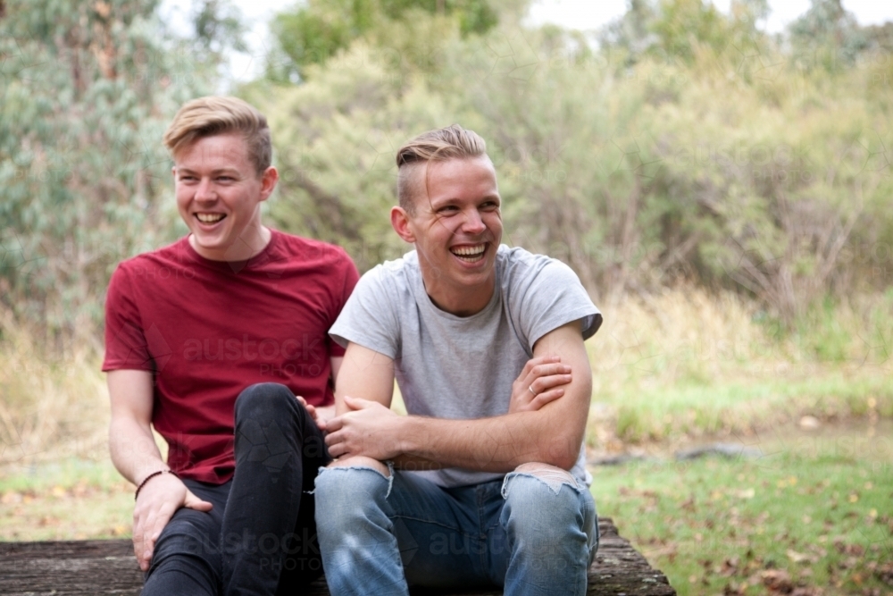 Young happy male same sex couple in a rural setting - Australian Stock Image