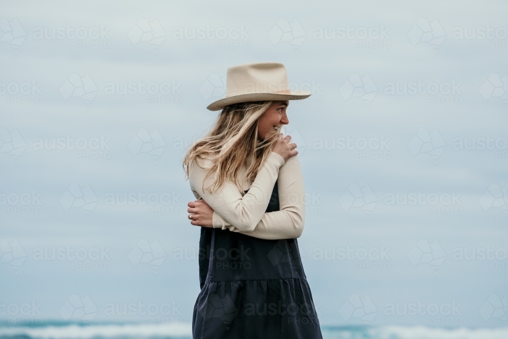 Young woman by the sea. - Australian Stock Image