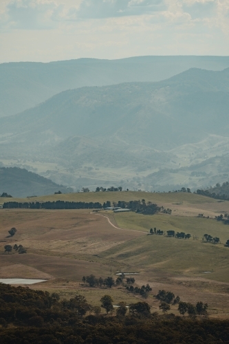 A rural homestead in the valley surrounded by mountains as seen from Blackheath Lookout
