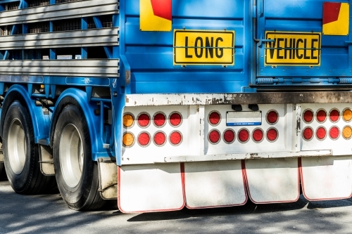 A sign reading 'Long Vehicle' on the back of a semi trailer road train used to transport animals
