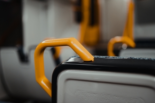 A yellow handrail detail on a Sydney Metro train
