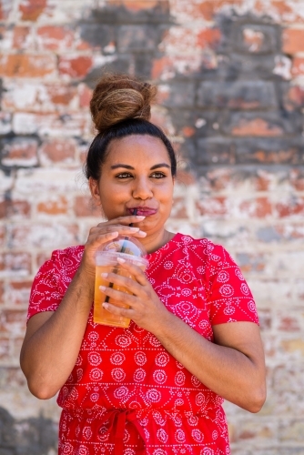 aboriginal woman drinking juice